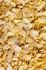 dry breakfast corn flakes of yellow color , close up