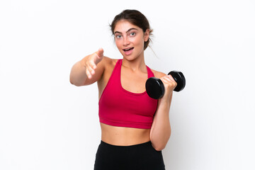 Fototapeta na wymiar Young sport caucasian woman making weightlifting isolated on white background shaking hands for closing a good deal