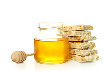 Nougat, jar of honey and dipper isolated on white background