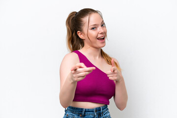 Young caucasian girl isolated on white background surprised and pointing front