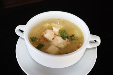 delicious and healthty chicken soup in a white bowl