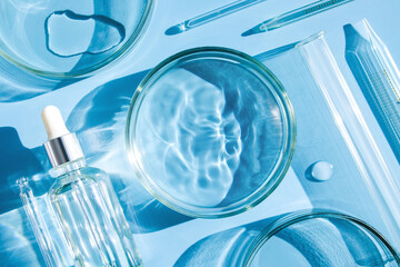 serum in petri dishes on light blue background cosmetic research concept	
