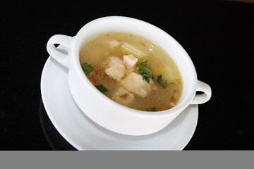 delicious and healthty chicken soup in a white bowl