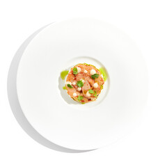 Restaurant dish - shrimp tartare with avocado, cream cheese, sweet chilli sauce on white plate. Ceviche with marinated prawn, avocado and spicy vegetables. Prawn tartare isolated on white background.