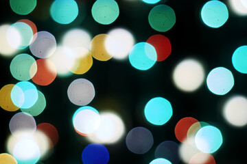 Fototapeta premium multicolored festive lights on a black background screensaver backdrop