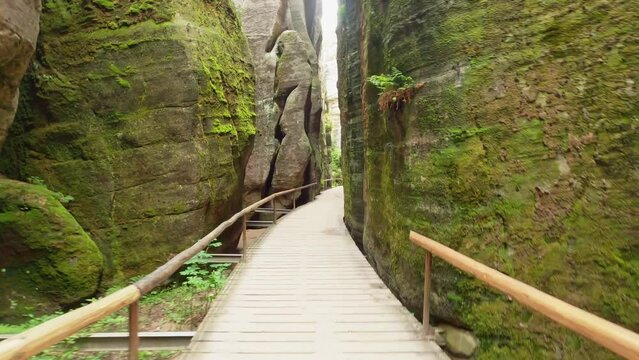 POV from hiking the wooden planks of the path through the steep sandstone cliffs in the rock town of Adersbach, Czech Republic.