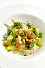 Green salad with broccoli, avocado, shrimps on white plate. Healthy dinner - Salad broccoli and prawns. Clean eating. Green bowl with vegetables and shrimps. Tempura broccoli with avocado