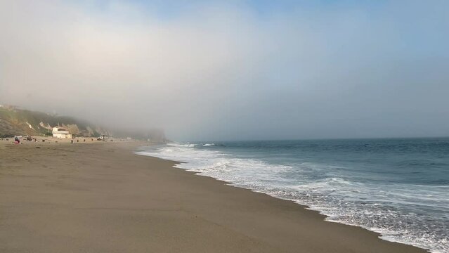 4k Malibu Beach Blue and Green Ocean waves crash into the shore on a cloudy day b roll