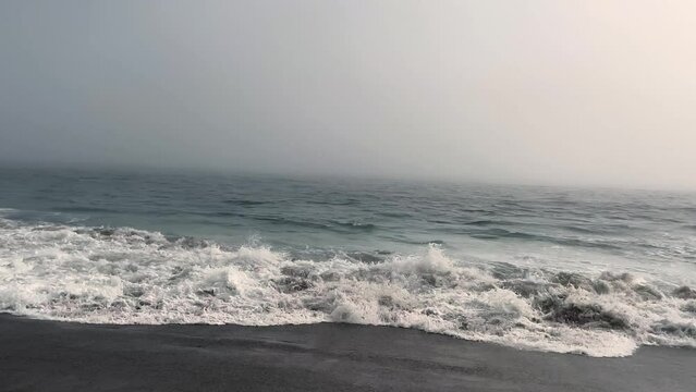 4k Malibu Beach Blue and Green Ocean waves crash into the shore on a cloudy day b roll