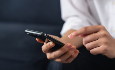 Hand holding smartphone with using social media on internet.