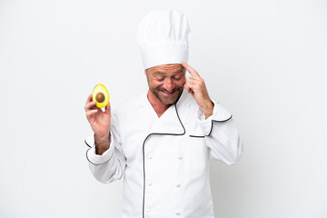 Chef man holding an avocado isolated on white background laughing