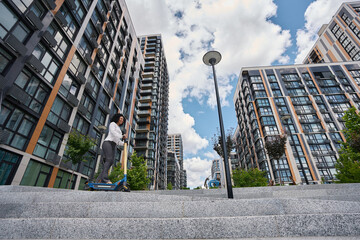 Low angel view of multiracial woman on scooter © Svitlana