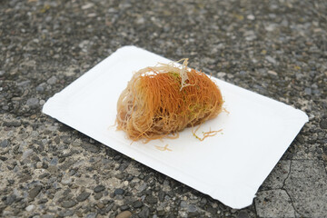 Selective focus picture of Turkish Baklava serve on the paper plate.