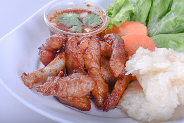 Sticky rice with fried pork on white bowl for Thai food and isolate background 