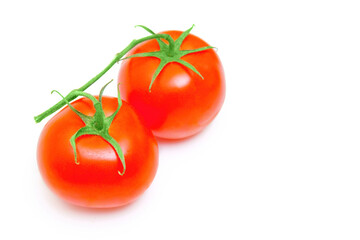 Two cocktail tomatoes on a vice isolated