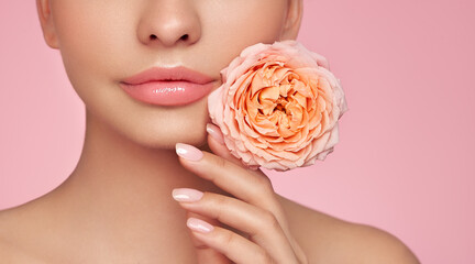 Beautiful model with a rose. Perfect woman face makeup close up. Lipstick. Beautiful nails. Nice...
