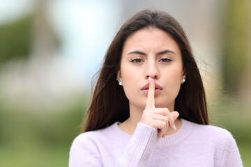 Serious teen asking for silence in the street