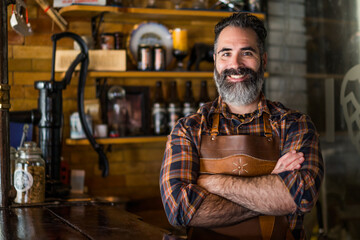 Portrait of cheerful barmen at pub.