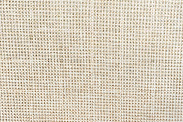 closeup macro of a light beige woven linen like fabric with detail of pattern and texture
