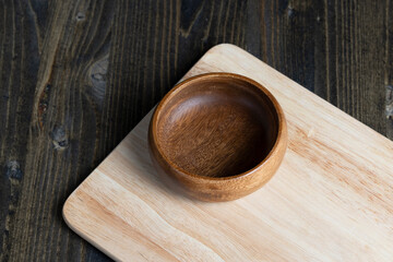 wooden plate on cutting board and black wooden table