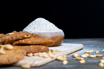 oatmeal cookies with peanuts on a black wooden table