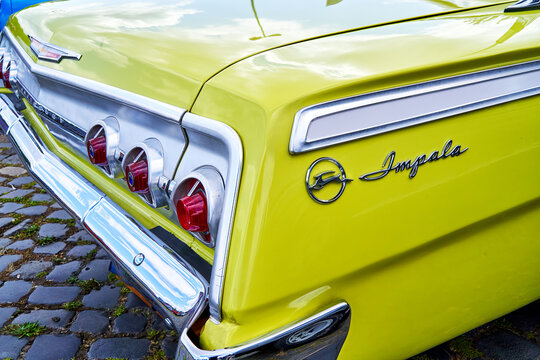 Chevrolet Impala rear end close up view, yellow painted classic american automobile