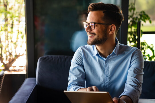 Portrait Of Young Business Man Working On Digital Tablet