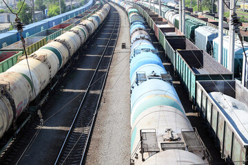 Freight wagons at the railway station. Tanks with fuel, oil. Energy crisis concept.
