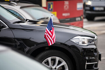 Small American Flag with stars and stripes on the luxury black car. Diplomatic car of USA....