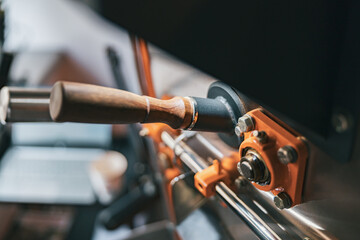 Close up of coffee roasting machine with coffee beans in small coffee manufacturing