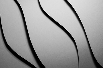 Grey carbon textured abstract geometric background with soar vertical curved waves with black shadows in graphic minimalist monochrome business style.