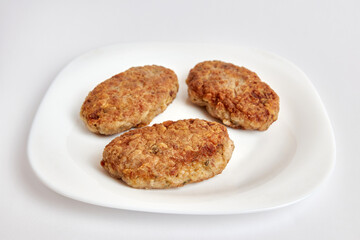 Fried meatballs on a white plate.