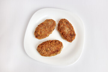 Fried meatballs on a white plate.