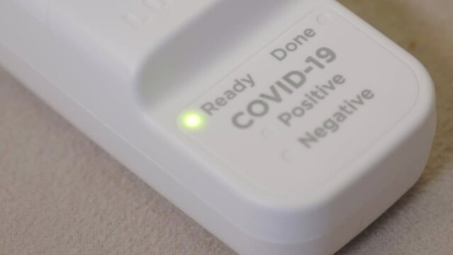 Ready Light Blinking On Test Unit Of COVID-19 Test Kit. - close up