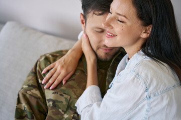 Happy wife embracing husband back from war