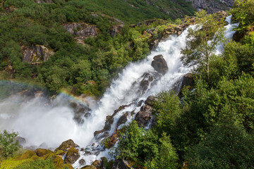 Fototapeta na wymiar Rainbow and Briksdal waterfall in Norway