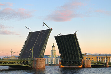 Fototapeta na wymiar Divorced Palace Bridge over Neva on background of Peter Great Museum of Anthropology and Ethnography (Kunstkamera) at dawn, St. Petersburg