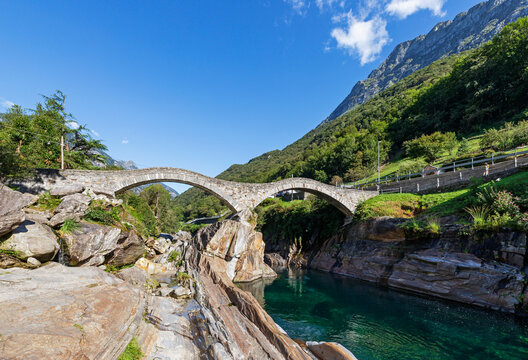 Switzerland, Ticino, Lavertezzo, Medieval Ponte dei Salti arch bridge in summer