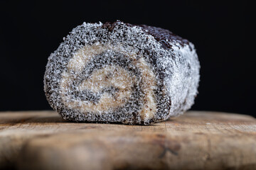 chocolate roll with a creamy curd layer in coconut chips