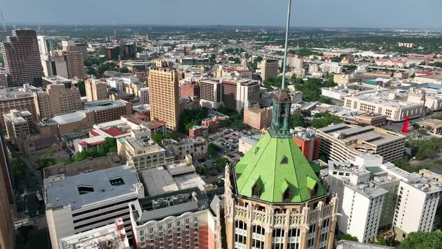 Downtown San Antonio Texas with American USA flag waving in wind. Rising aerial.
