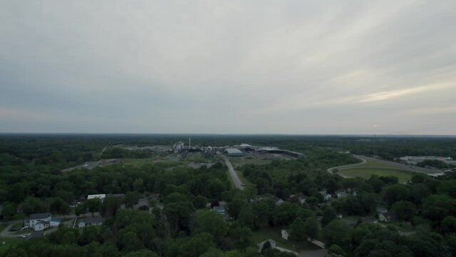 Drone view of beautiful town covered by trees in evening