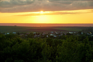 Panoramic view of the sunset over the valley and the village. Landscape and nature backgrounds