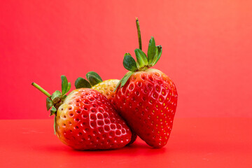 Strawberry isolated in red background 