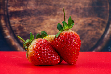 Strawberry isolated in red background 