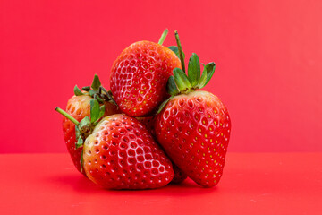 Strawberry isolated in red background 