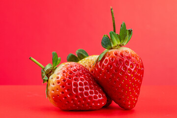Strawberry isolated in red background 