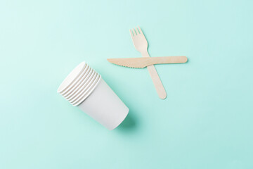 Wooden cutlery on the green background. Eco friendly table ware , zero waste concept. Reuse, reduce, recycle.