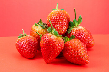 Strawberry isolated in red background 