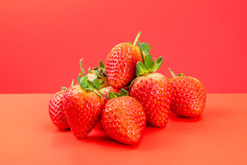 Strawberry isolated in red background 