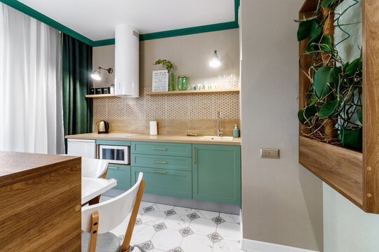 Interior Of The Modern Kitchen In Studio Apartments In Minimalistic Style With Green Color